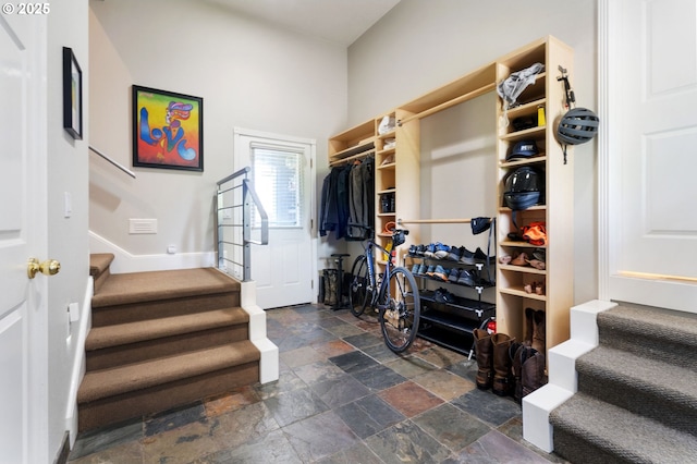 walk in closet with stone tile floors