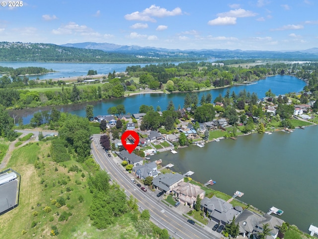 aerial view of property's location with a water and mountain view