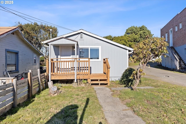 view of front of home with a front lawn and a deck