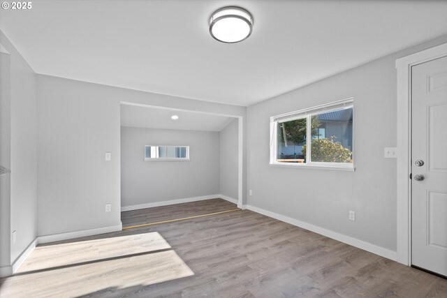 unfurnished room featuring a healthy amount of sunlight and light hardwood / wood-style floors