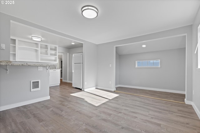 unfurnished living room featuring light wood-type flooring