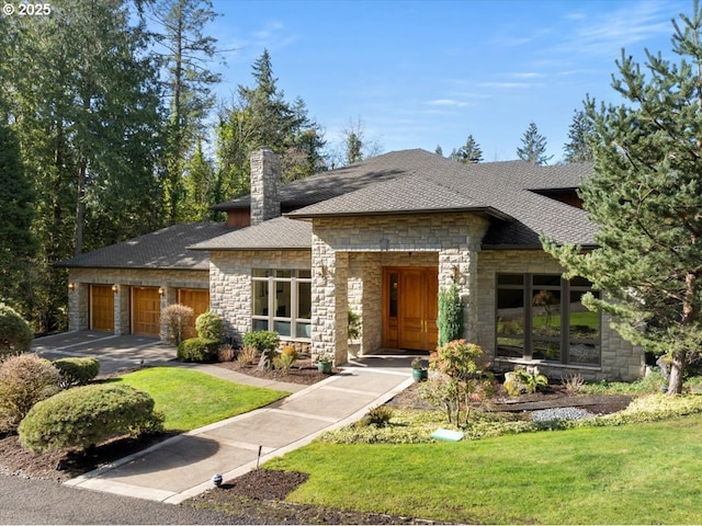 view of front of house with a front lawn, an attached garage, roof with shingles, and a chimney