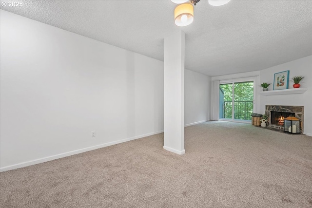 12618 NW Barnes Rd Unit 11, Portland, OR 97229 - living room featuring carpet flooring, a textured ceiling, and a fireplace