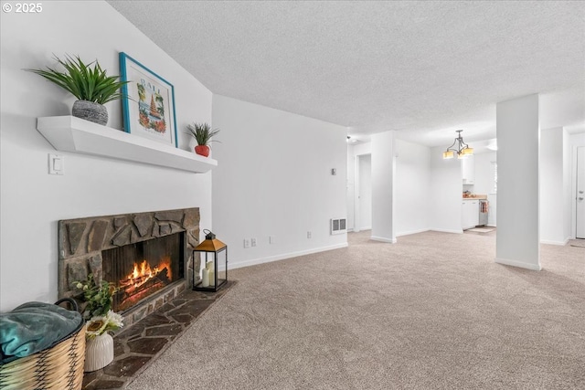 12618 NW Barnes Rd Unit 11, Portland, OR 97229 - carpeted living area with a fireplace, a textured ceiling, and a chandelier