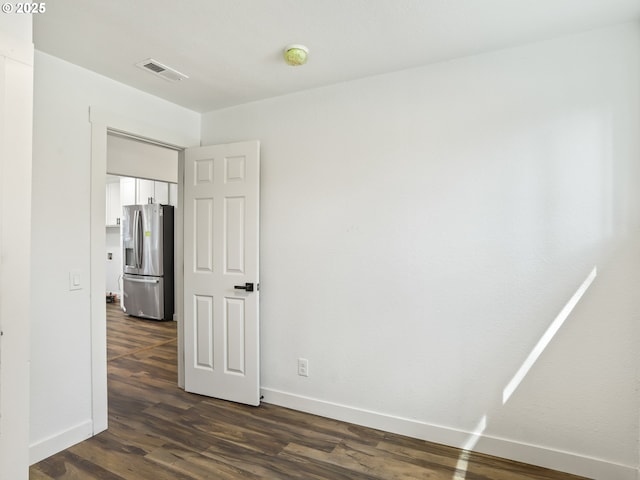 3241 SE 150th Ave, Portland, OR 97236 - unfurnished bedroom with baseboards, visible vents, stainless steel fridge, and dark wood-type flooring