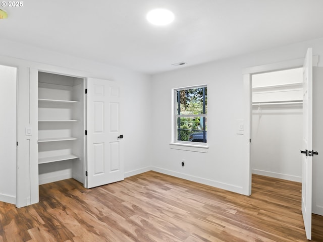 3241 SE 150th Ave, Portland, OR 97236 - unfurnished bedroom with a closet, light wood-style flooring, baseboards, and a spacious closet