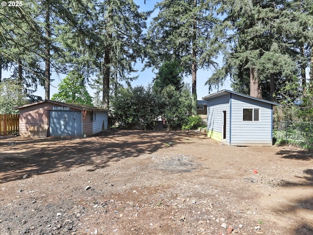 3241 SE 150th Ave, Portland, OR 97236 - view of yard with fence, an outbuilding, and dirt driveway