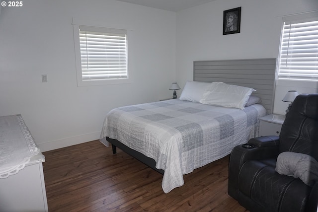 bedroom featuring baseboards and wood finished floors