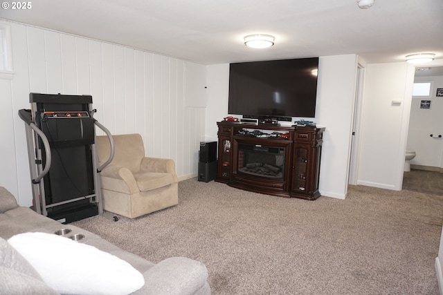 living room featuring carpet floors and a glass covered fireplace