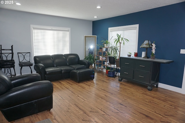 living area with hardwood / wood-style flooring, baseboards, and recessed lighting