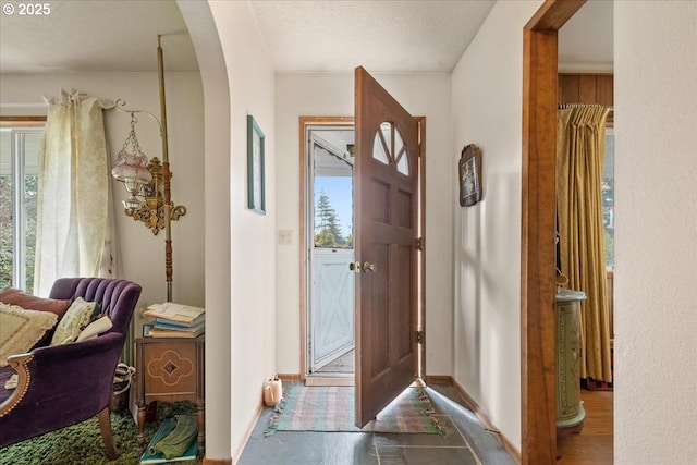 entryway with a textured ceiling