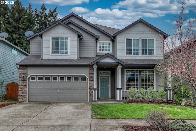3801 NE 93rd St, Vancouver, WA 98665 - view of front of home featuring an attached garage, a shingled roof, concrete driveway, and stone siding