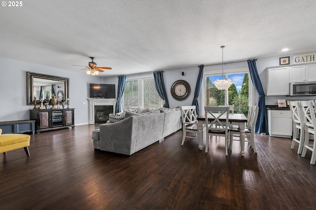 3801 NE 93rd St, Vancouver, WA 98665 - living room with a wealth of natural light, dark wood-type flooring, a textured ceiling, and ceiling fan with notable chandelier
