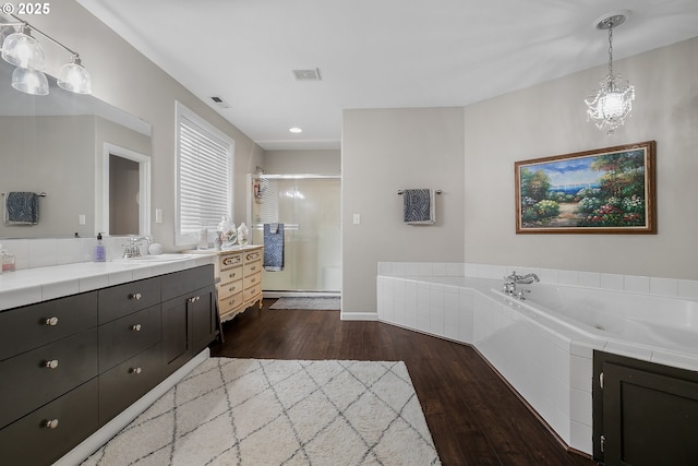 3801 NE 93rd St, Vancouver, WA 98665 - bathroom featuring a garden tub, a shower stall, vanity, a chandelier, and wood finished floors