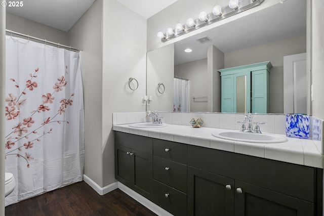 3801 NE 93rd St, Vancouver, WA 98665 - bathroom featuring wood finished floors, double vanity, a sink, and baseboards