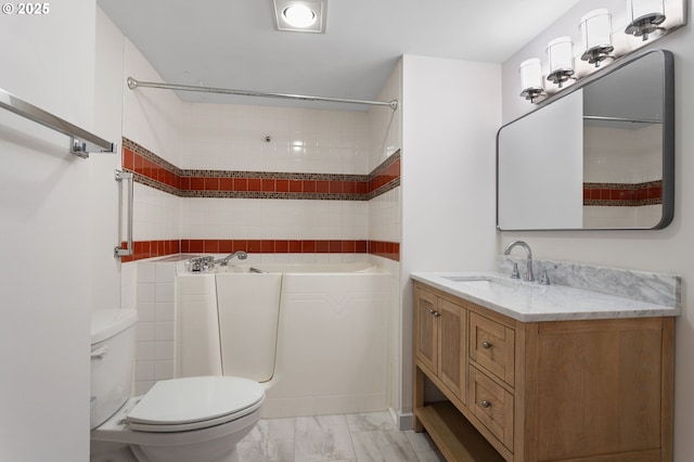 full bath with toilet, marble finish floor, and vanity