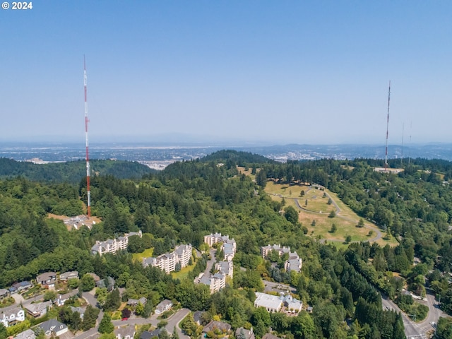 birds eye view of property featuring a wooded view