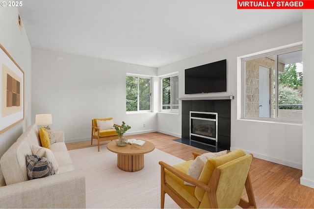 6685 W Burnside Rd Unit 310, Portland, OR 97210 - living area featuring wood finished floors and a tiled fireplace
