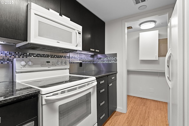 kitchen with decorative backsplash, white appliances, light wood-type flooring, and dark cabinets