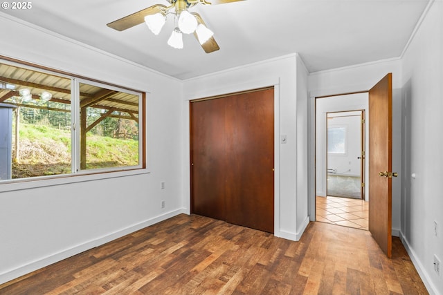 95116 Marcola Rd, Marcola, OR 97454 - unfurnished bedroom with a ceiling fan, wood finished floors, a closet, baseboards, and ornamental molding