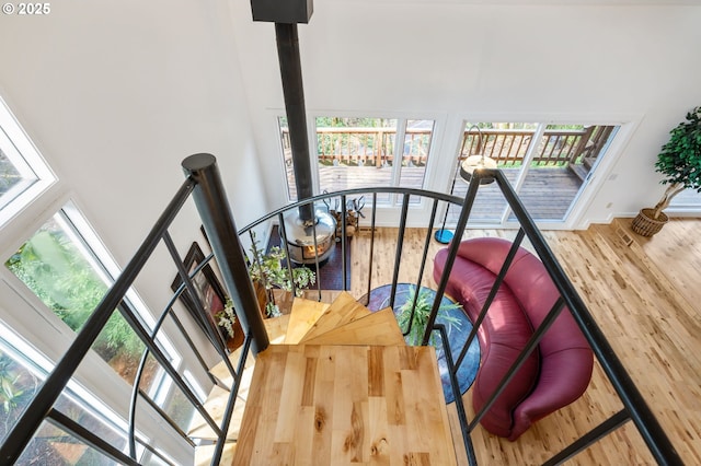 staircase featuring a high ceiling and wood finished floors