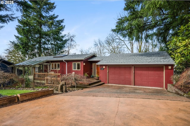 ranch-style home featuring a garage and concrete driveway