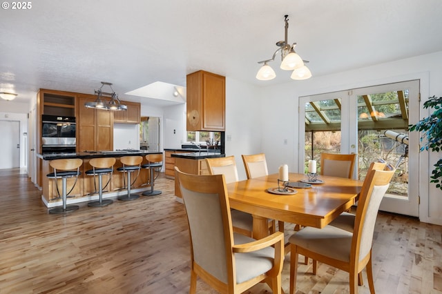 dining area featuring a chandelier and light wood finished floors