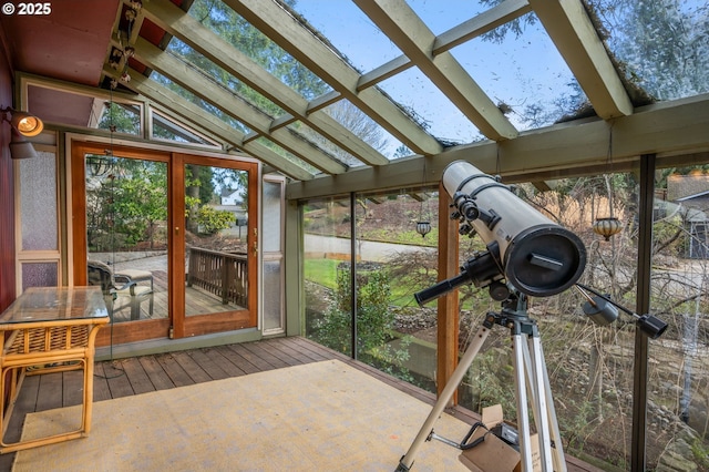 sunroom featuring lofted ceiling with skylight