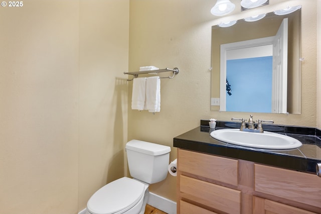 bathroom with toilet and vanity