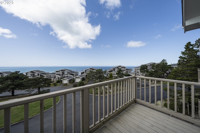 wooden terrace featuring a water view and a residential view