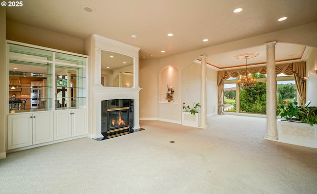 12033 S Shadow Hills Ct, Turner, OR 97392 - unfurnished living room with carpet, decorative columns, a fireplace with flush hearth, recessed lighting, and baseboards