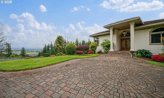 12033 S Shadow Hills Ct, Turner, OR 97392 - exterior space featuring french doors, a front yard, and stucco siding