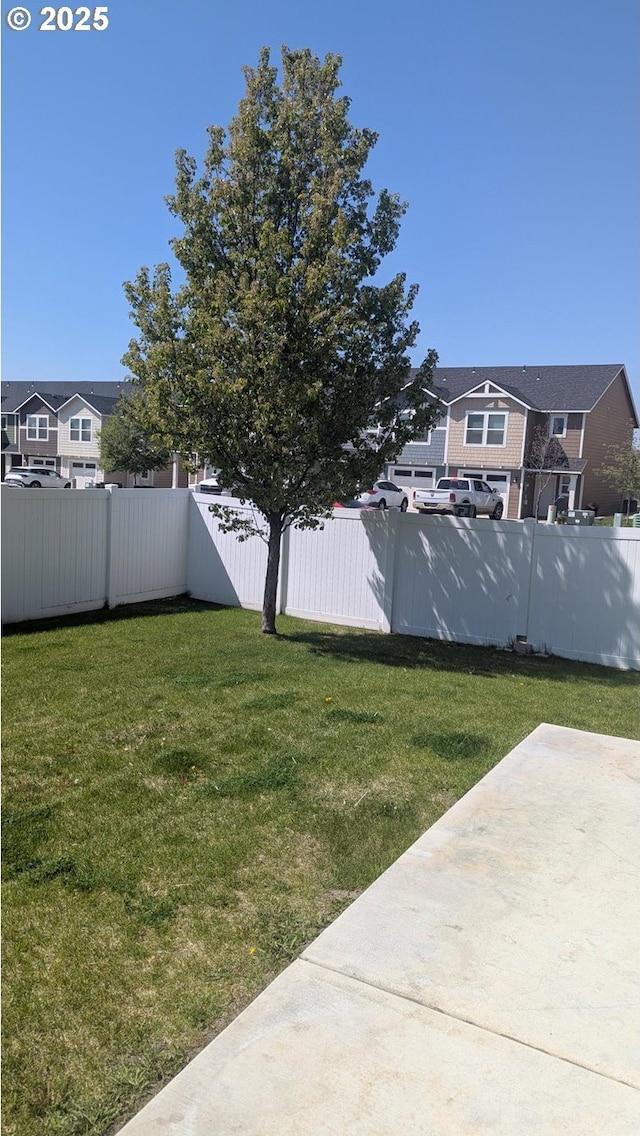 view of yard featuring a patio and a fenced backyard