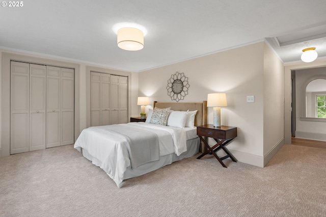 2815 NE 35th Ave, Portland, OR 97212 - carpeted bedroom featuring multiple closets, baseboards, crown molding, and attic access