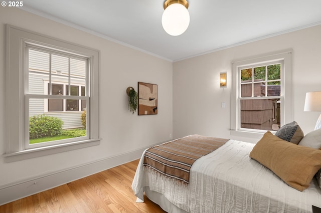2815 NE 35th Ave, Portland, OR 97212 - bedroom with wood finished floors, crown molding, and baseboards