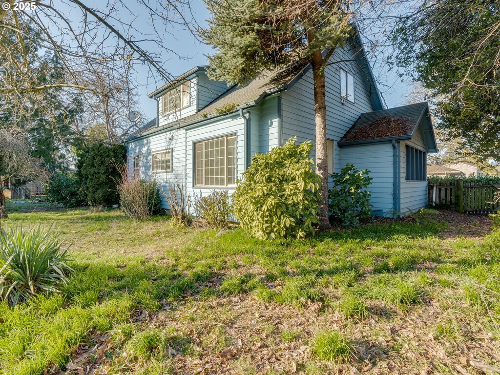 view of side of home featuring a yard