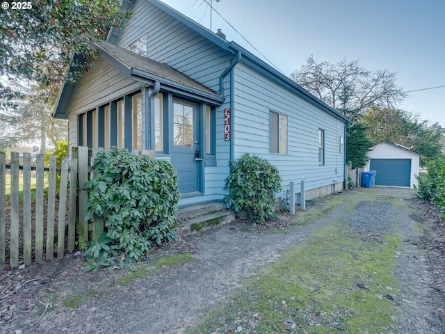 view of front facade featuring an outbuilding and a garage