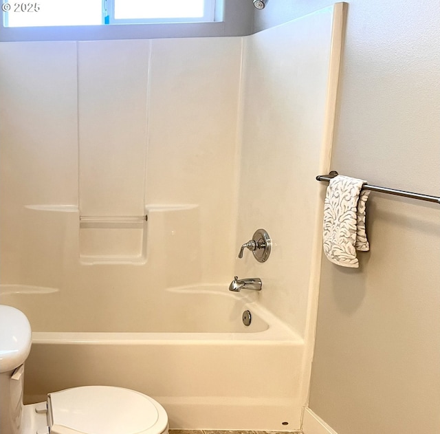 bathroom featuring toilet and tub / shower combination