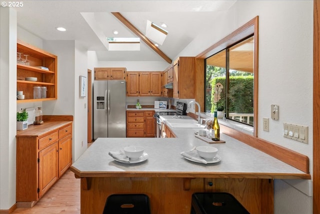 115 Willow St, Silverton, OR 97381 - kitchen with stainless steel refrigerator with ice dispenser, range with electric cooktop, a skylight, open shelves, and light countertops