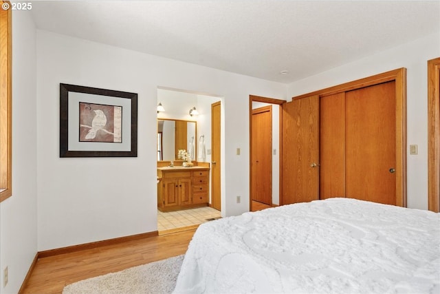 115 Willow St, Silverton, OR 97381 - bedroom with light wood-style flooring, connected bathroom, and a closet