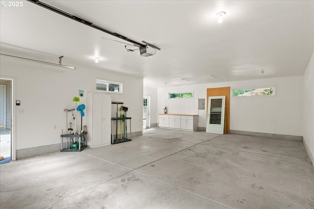 115 Willow St, Silverton, OR 97381 - garage featuring a garage door opener and electric panel