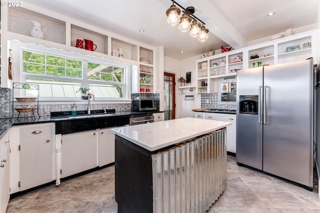 kitchen with open shelves, beam ceiling, decorative backsplash, appliances with stainless steel finishes, and a sink