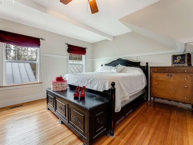 bedroom with a ceiling fan, visible vents, light wood finished floors, and baseboards