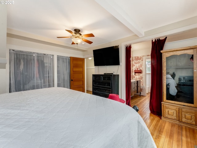 bedroom featuring beam ceiling, a ceiling fan, and hardwood / wood-style flooring