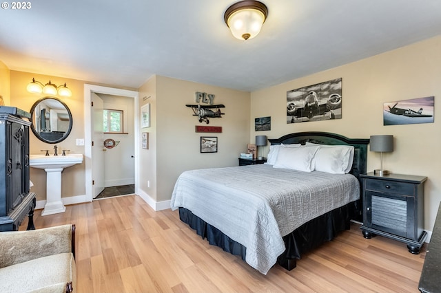 bedroom with baseboards and light wood-style floors