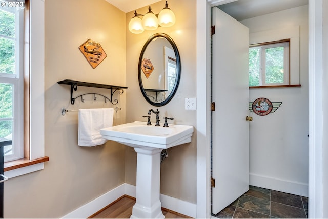 bathroom featuring stone finish flooring and baseboards