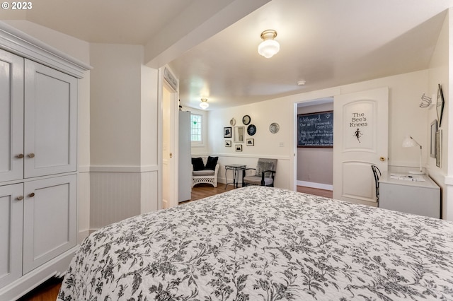 bedroom with a wainscoted wall