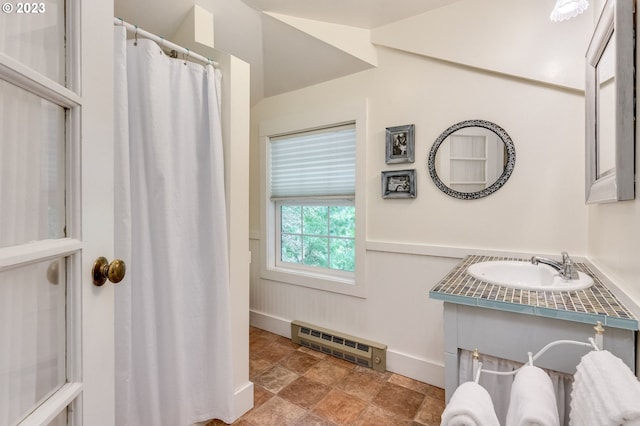 full bathroom with vanity, stone finish flooring, and baseboards