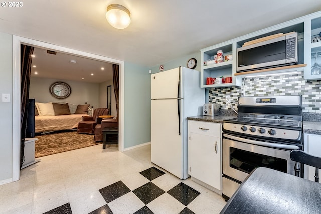 kitchen featuring light floors, open shelves, decorative backsplash, appliances with stainless steel finishes, and dark countertops