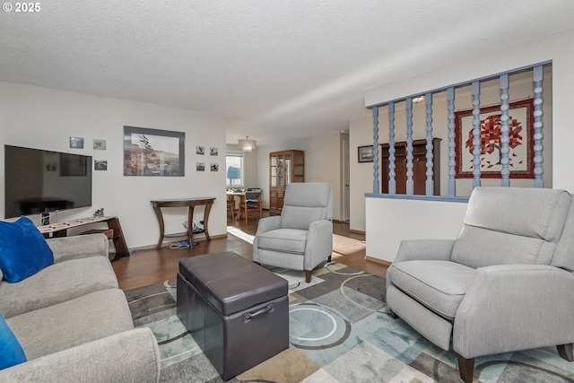 5355 SW 205th Ct, Beaverton, OR 97078 - living room featuring wood finished floors, a textured ceiling, and baseboards